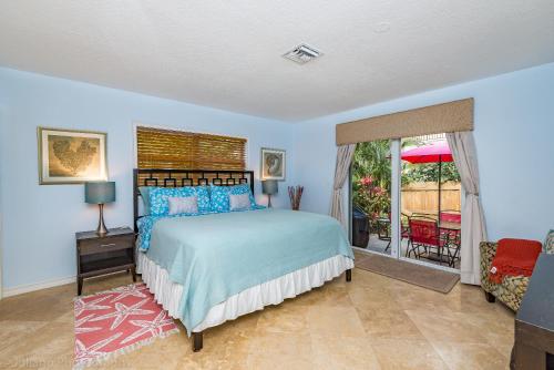 a bedroom with a bed and a balcony at Highland Beach Retreat- Short walk to beach in Highland Beach