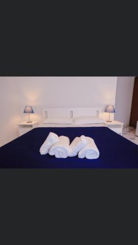 a bedroom with a bed with three towels on it at Casa Adele b&b in Pozzuoli