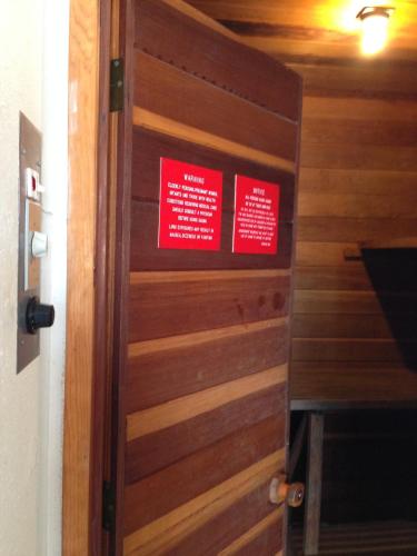 a wooden door with red signs on it at Redwood Inn in Crescent City
