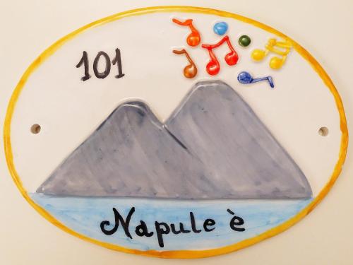 a plate with a sign with a mountain at B&B Terra Mia Napoli in Naples