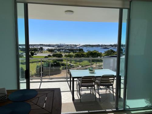 a view from the balcony of a house with a table and chairs at Marina ocean view at Shores Southport in Gold Coast