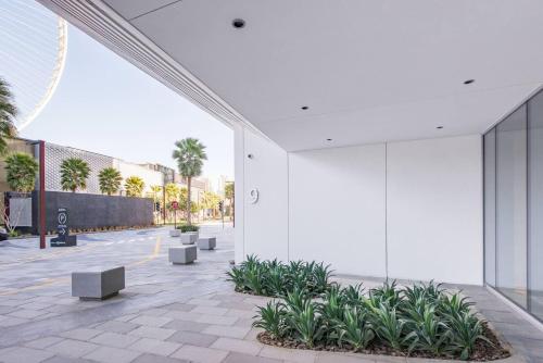 a courtyard with benches and plants in a building at Spectacular 3 BR condo with maids room facing the Dubai Eye in Dubai
