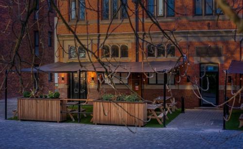 a building with a table and chairs in front of it at Phoenix Hotel Liverpool in Liverpool