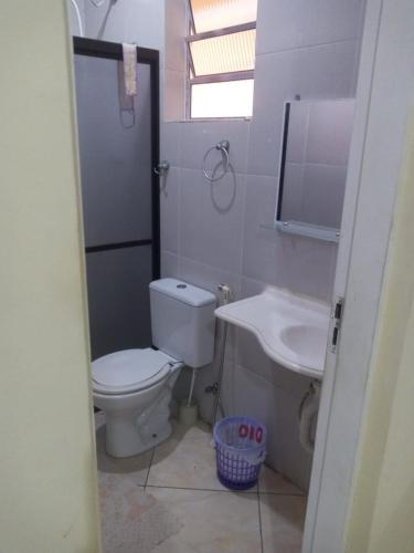 a bathroom with a toilet and a sink at Maydã in Praia Grande