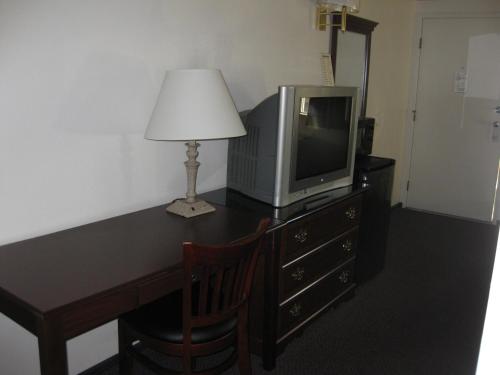 a desk with a television and a lamp on it at Sunrise Inn in Everett