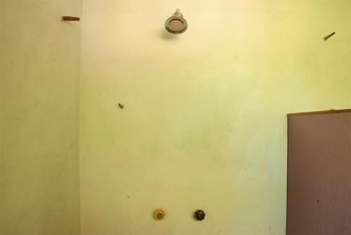 a wall with a clock on the side of a room at M a r e a V i v a - O a x a c a in Zipolite