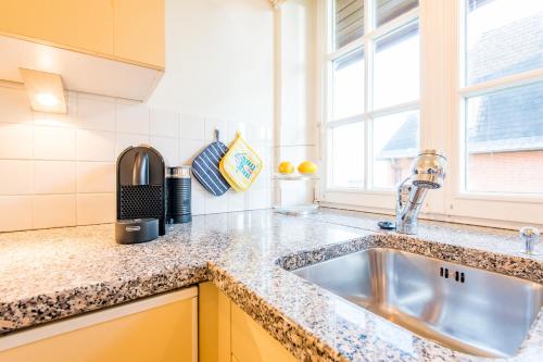 a kitchen with a sink and a window at Oceanview in Kampen