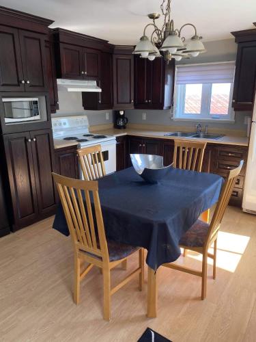 a kitchen with a table with a bowl on it at Maison Carofanne in Saint-Siméon