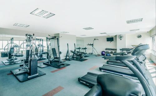 a gym with several treadmills and machines in it at Greenhills Elan Hotel Modern - Newly Renovated in Manila