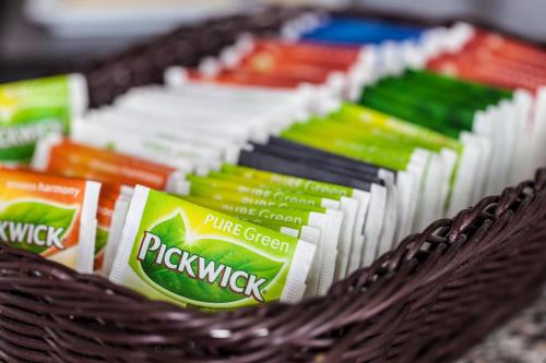 a basket filled with different types of packets of toothpaste at Hotel Stad en Land in Alkmaar