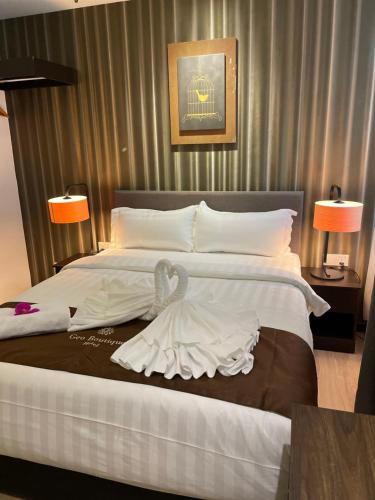 a bedroom with a large bed with a swan on it at Geo Boutique Hotel - Seri Kembangan in Seri Kembangan