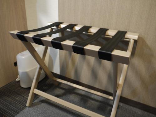 a black and white bed in a bathroom with a toilet at Hotel Route-Inn Yonago in Yonago