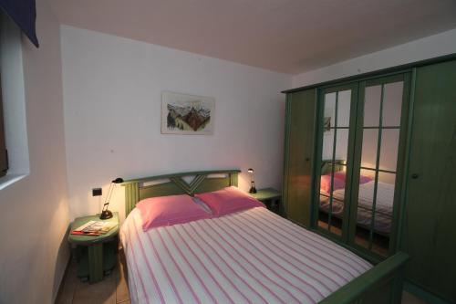 a bedroom with a bed and a green cabinet at Chalet Bouquetin- Mouflon in Champagny-en-Vanoise