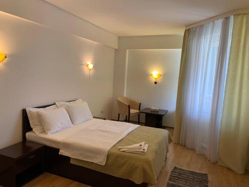 a hotel room with a bed with a towel on it at Casa Ruxandrei in Constanţa