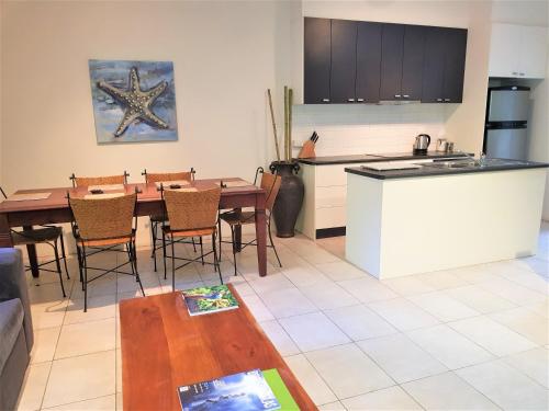 A kitchen or kitchenette at Coral Sea Villas