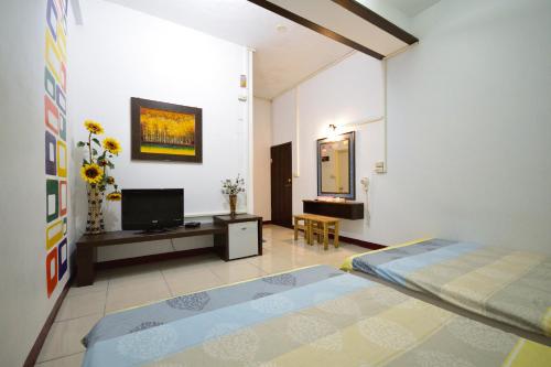 a bedroom with a bed and a tv in a room at Luyi Ludao B&B in Green Island