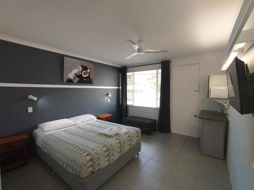 a bedroom with a bed and a person taking a picture at Aspley Sunset Motel in Brisbane