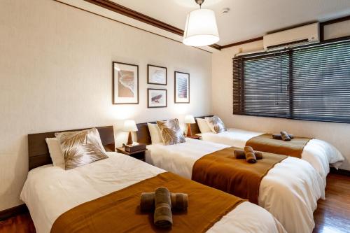 Ένα ή περισσότερα κρεβάτια σε δωμάτιο στο Type B Room 63平米 -ウル エスポワール石垣-