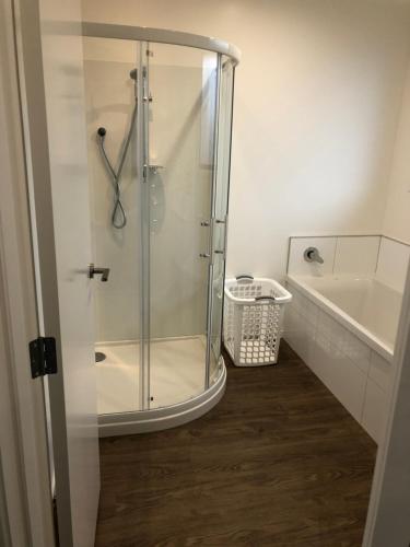 a shower with a glass door in a bathroom at The Drydock in Stratford