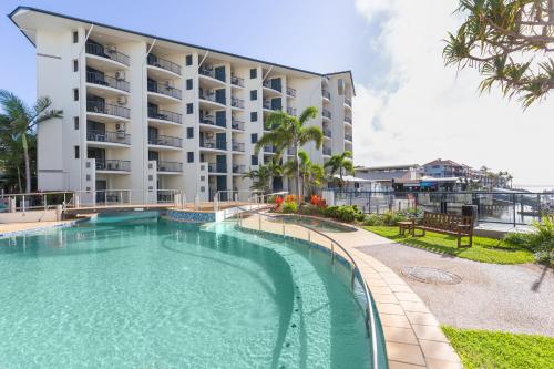 a swimming pool in front of a building at Mantra Hervey Bay in Hervey Bay
