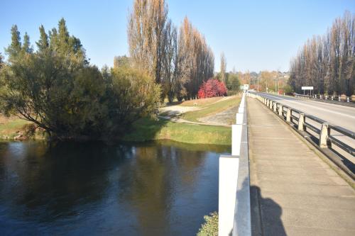 a bridge over a river next to a road at Tumut Farrington motel in Tumut