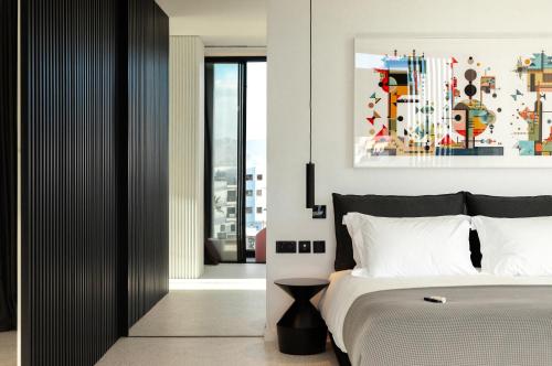 a bedroom with a bed and a painting on the wall at MAP Boutique Hotel in Nicosia