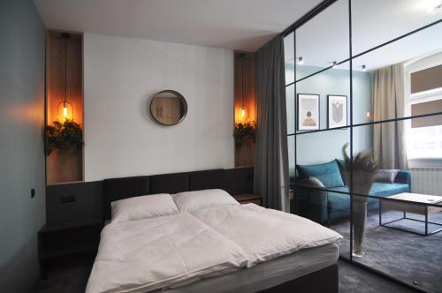 a bedroom with a bed and a glass wall at Apartamenty Centrum Chodzież in Chodzież