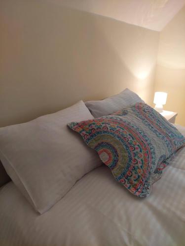 a bed with a pillow and two pillows on it at Sunny Funny House in Čačak