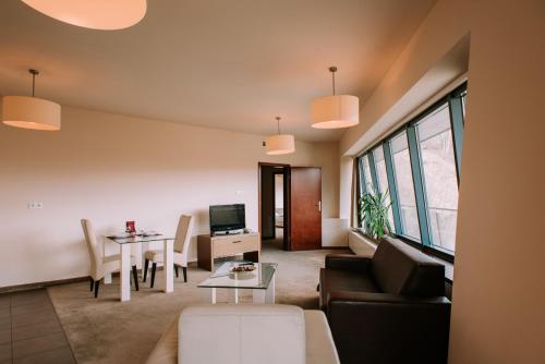 a living room with a couch and a table at Szklane Domy in Zakopane