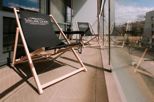 a row of chairs sitting on top of a building at Szklane Domy in Zakopane