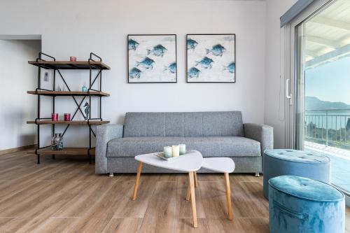 a living room with a couch and a table at Villa Renata & Villa Filippos with private Plunge Pool by Konnect in Agios Gordios