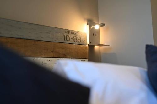 a bedroom with a bed and a clock on the wall at L'Arche de Porquerolles in Porquerolles
