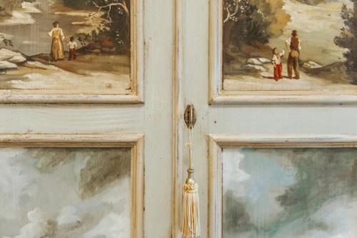 a door with three paintings on it at Hotel Aganoor in Castiglione del Lago
