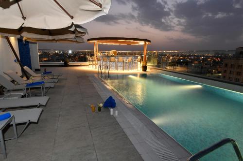 a swimming pool on the roof of a building at Golden Tulip Riyadh in Riyadh