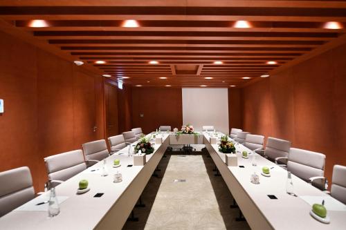 a large conference room with a long table and chairs at Golden Tulip Riyadh Convention and Exhibition Center in Riyadh