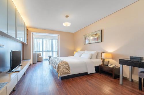מיטה או מיטות בחדר ב-Qingdao Housing International Hotel