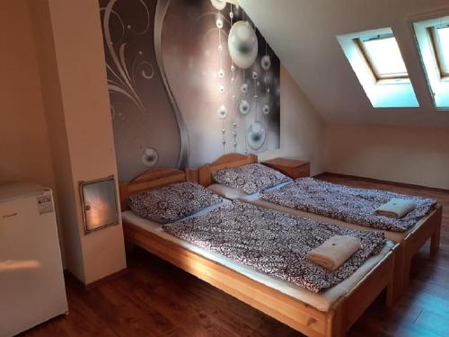A bed or beds in a room at Ponty-Poronty Vendégház