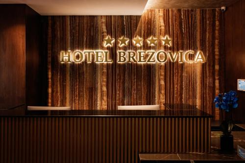 a hotel brezocka sign in front of a curtain at Brezovica Hotel & SPA in Brezovicë