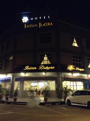 a hotel with a car parked in front of it at Hotel Intan Jugra in Banting