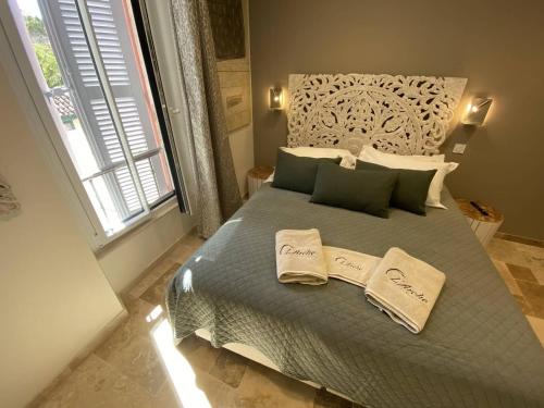 a bedroom with a bed with two towels on it at L'Arche de Porquerolles in Porquerolles