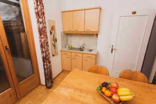 a kitchen with a table with a bowl of fruit on it at Lesachtalerhof in Liesing