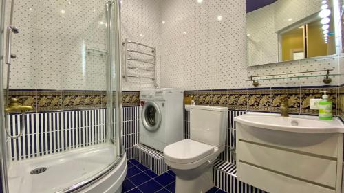 a bathroom with a toilet and a sink and a shower at a Apartments by SeaPort in Sochi