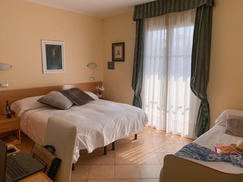 Postel nebo postele na pokoji v ubytování Hotel La Bitta