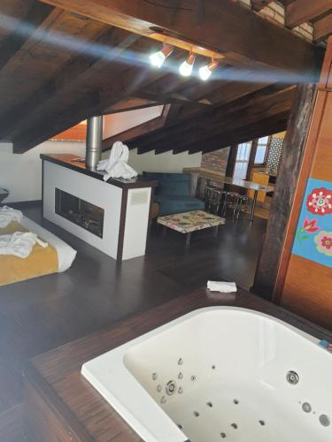 a bath tub in a room with a fireplace at Posada la Leyenda in Santillana del Mar