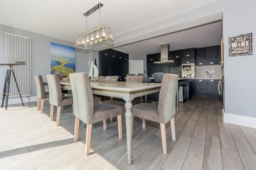 a kitchen and dining room with a table and chairs at Ocean View,Kinsale, Hosted by Exquisite holiday homes, sleeps 22 in Kinsale