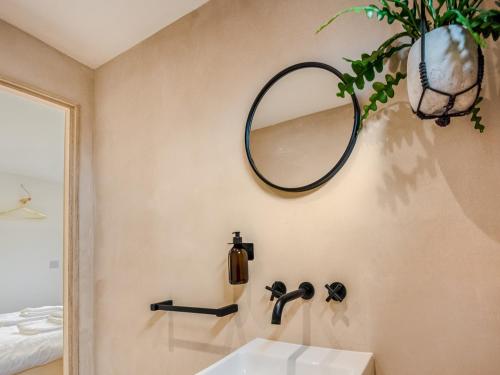 a bathroom with a sink and a mirror on the wall at Pass the Keys Whitstable Tiny house - a secret getaway! in Whitstable