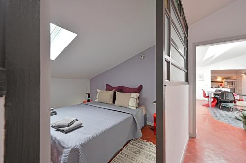 a bedroom with a bed and a dining room at Place Carnot 1900: Coeur de Ville in Avignon