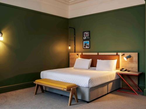a green bedroom with a bed and a bench at The Grand Bristol By Sunday in Bristol