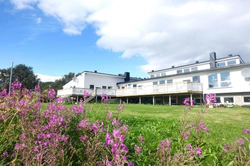 a building with purple flowers in front of it at Varangertunet Aldonen Apartment in Vadsø