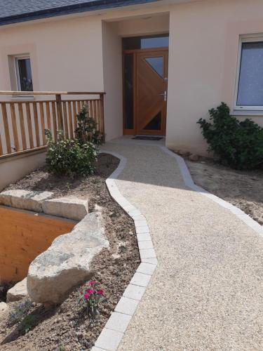 a walkway in front of a house with a door at chambre d'hôtes Les Hortensias in Saint-Jean-la-Poterie